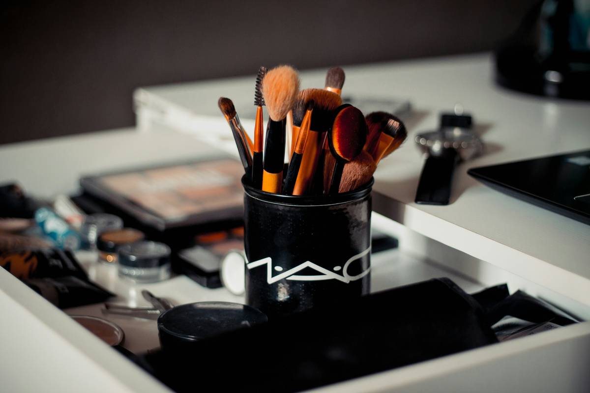 Close-up of a high-quality eyebrow styling tool with angled brush and spoolie on a clean vanity